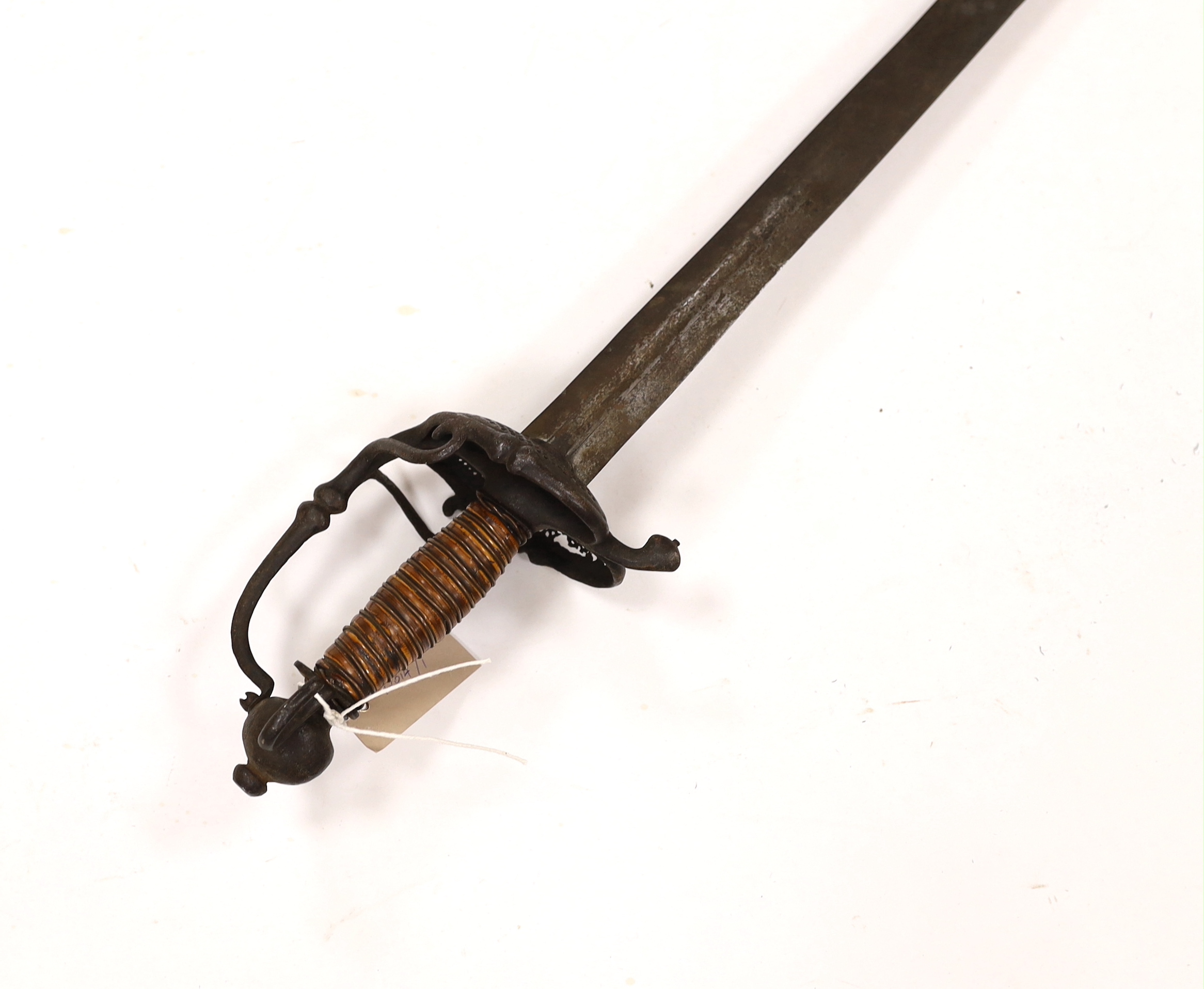 A 17th century Walloon-hilted small sword with pierced iron guard, replacement wooden grip and wide blade (possibly associated), blade 79cm